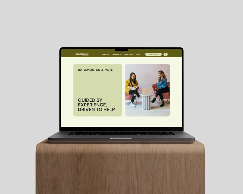 Humanalyze Consulting Mockup on Laptop on top of wooden stand