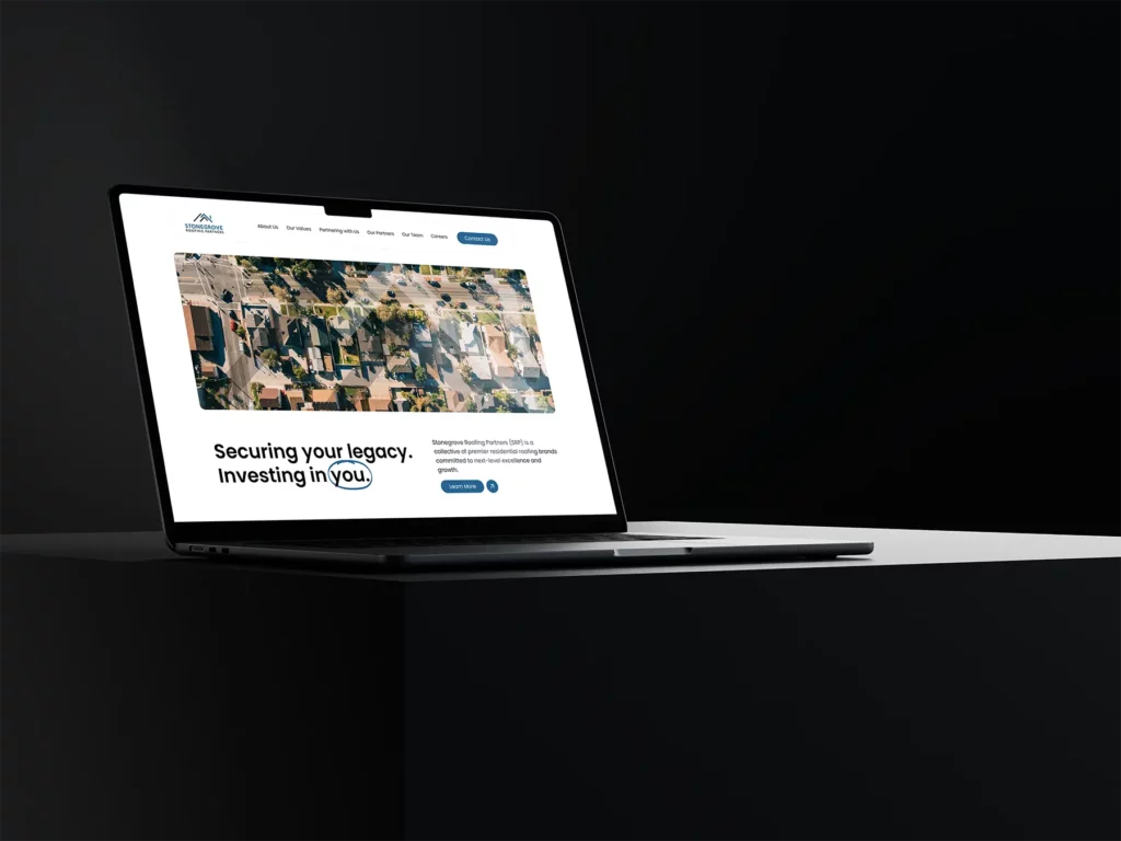 Stonegrove Roofing Partners Mockup on a Macbook on a table in black