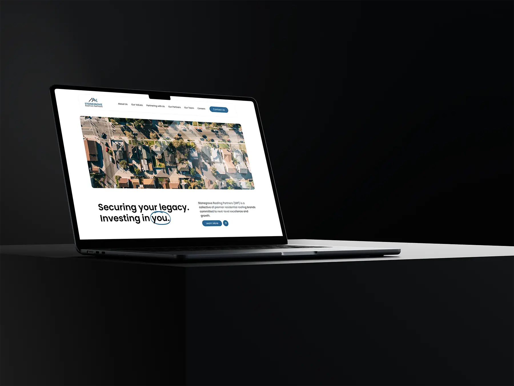 Stonegrove Roofing Partners Mockup on a Macbook on a table in black
